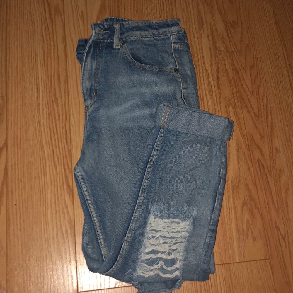 Ripped medium wash jeans.